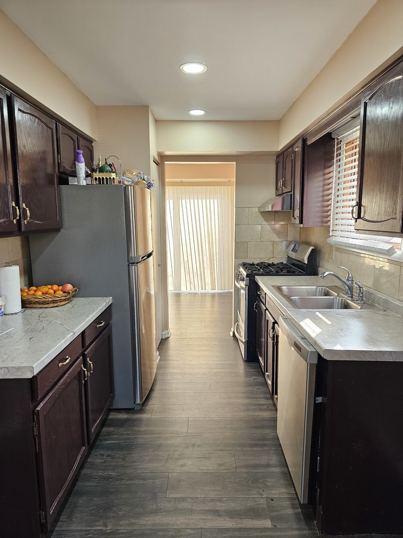 1529 Lighthouse Drive Naperville, IL 60565 - Photo 9 of 21 a kitchen with stainless steel appliances granite countertop a sink stove and refrigerator