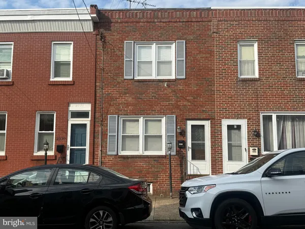a front view of a house with parking space