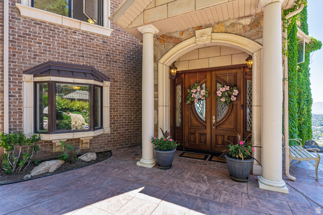 4093 North Imperial Way Provo, UT 84604 - Photo 4 of 96 Elegant double front doors with decorative glass panels and an arched stone surround
