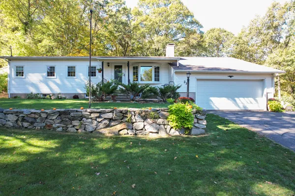 a front view of a house with garden