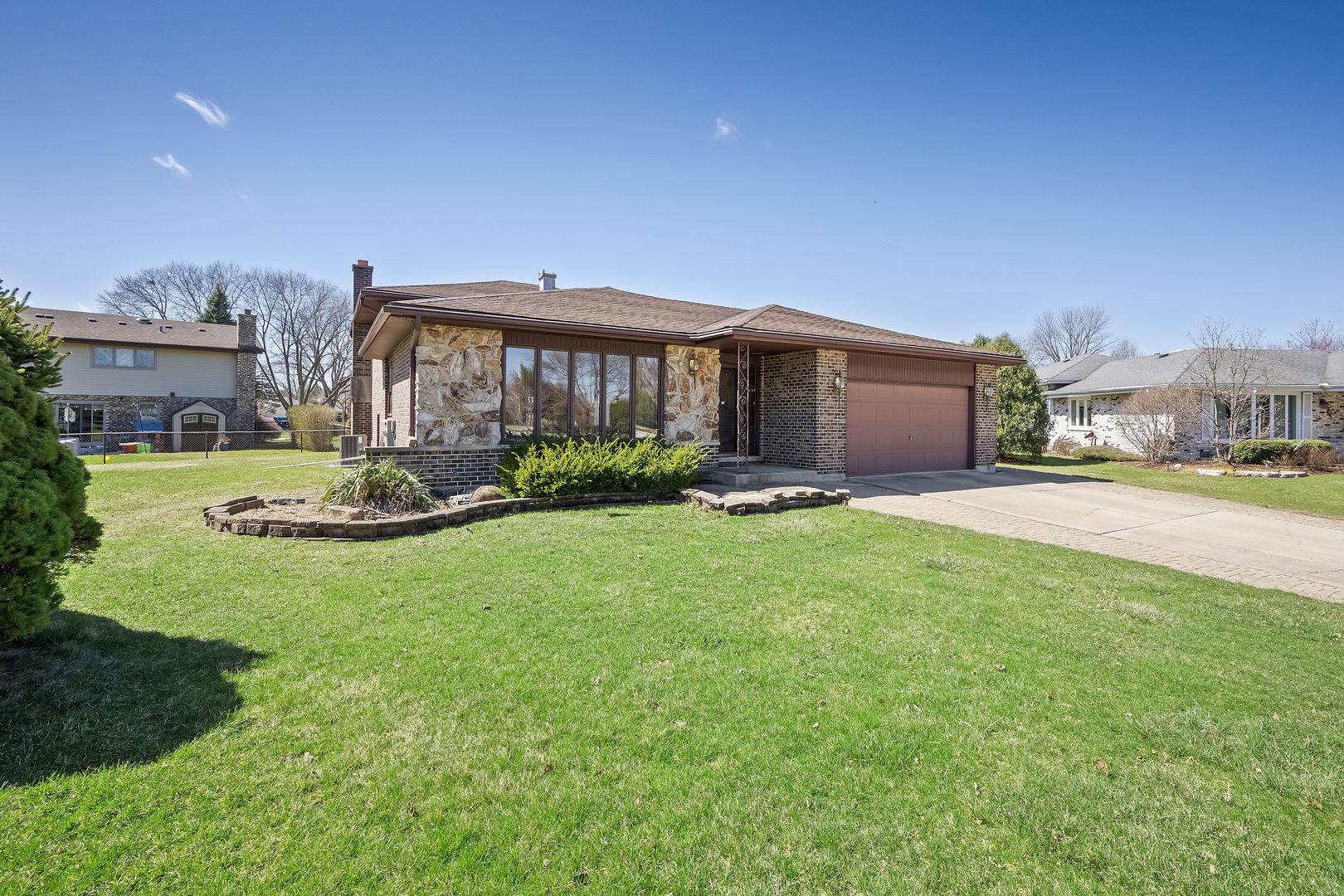 1631 Arbor Court Darien, IL 60561 - Photo 2 of 7 a front view of a house with a garden and plants