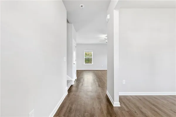 a view of a hallway with wooden floor