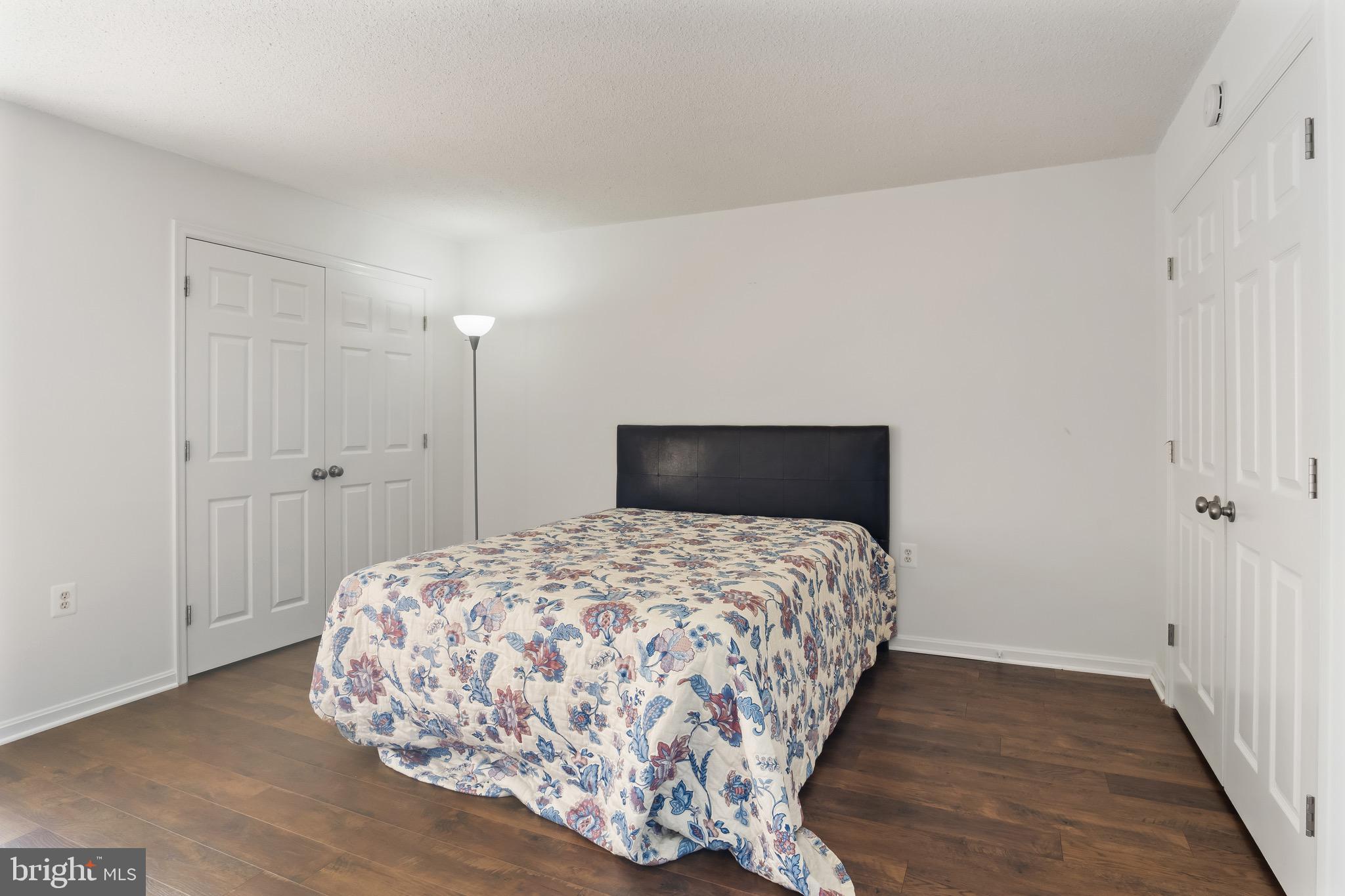 1301 North Courthouse Road, Unit 1401 Arlington, VA 22201 - Photo 19 of 34 a bedroom with a bed and wooden floor