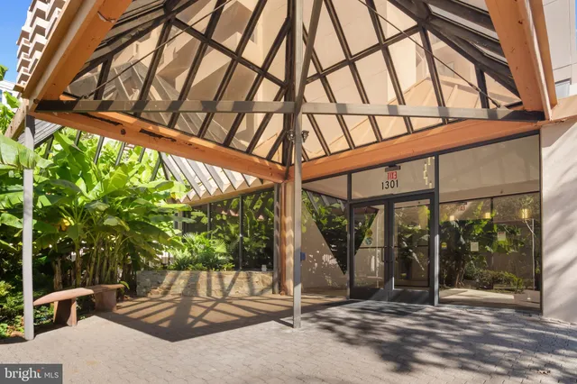 a building exterior with a table and chairs and potted plants