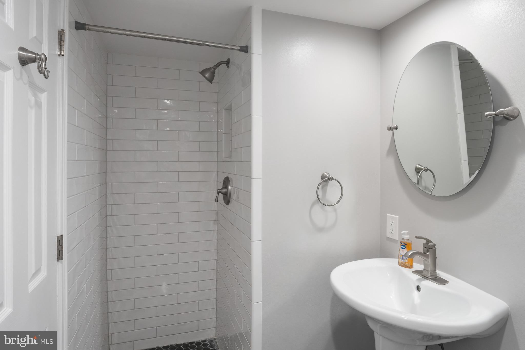 1301 North Courthouse Road, Unit 1401 Arlington, VA 22201 - Photo 21 of 34 a bathroom with a sink mirror and shower