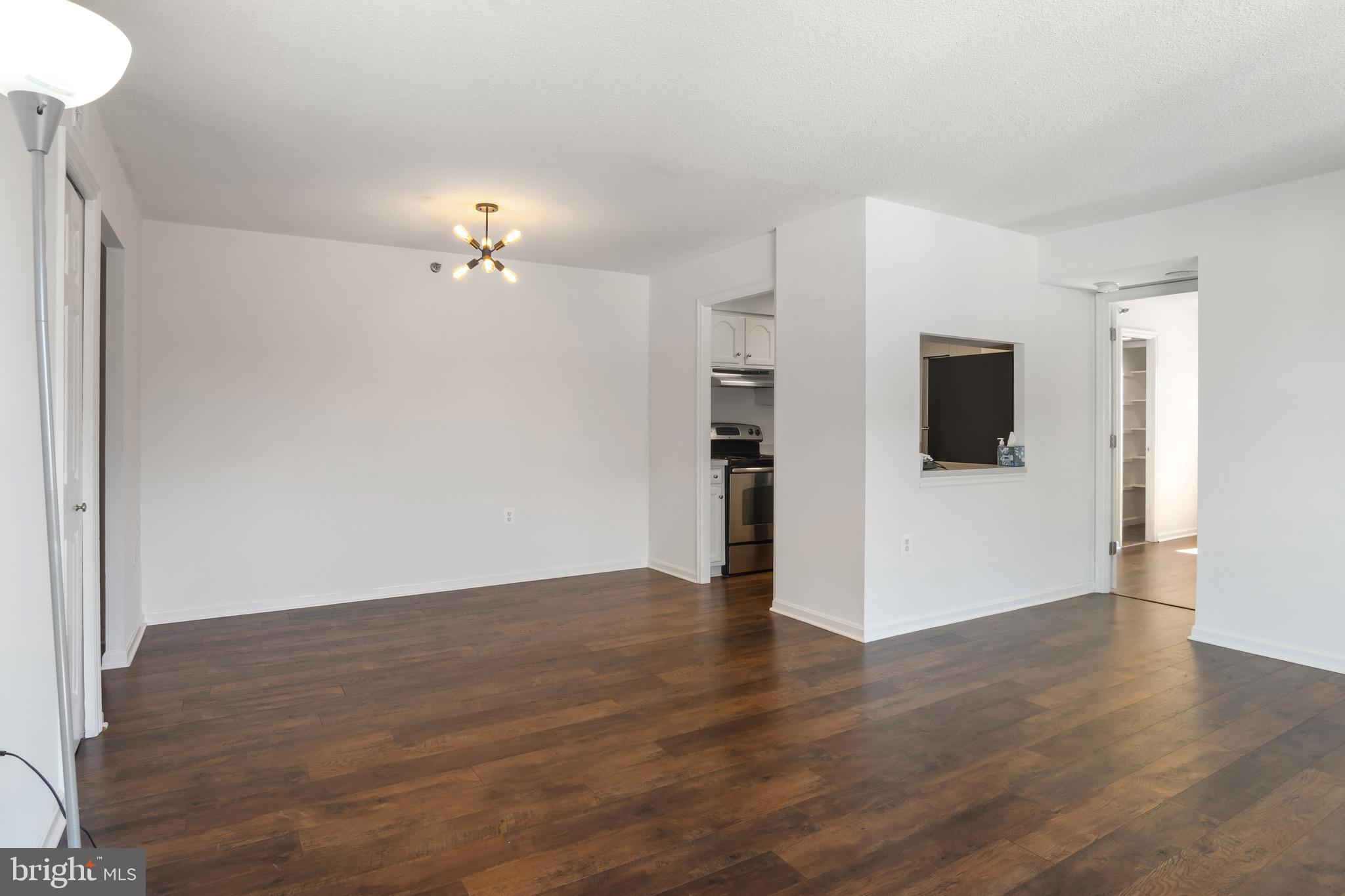 1301 North Courthouse Road, Unit 1401 Arlington, VA 22201 - Photo 7 of 34 a view of a room with wooden floor and a ceiling fan
