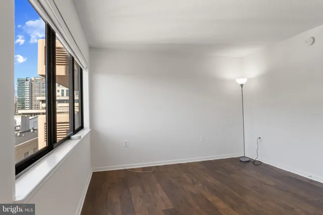 a view of an empty room and wooden floor