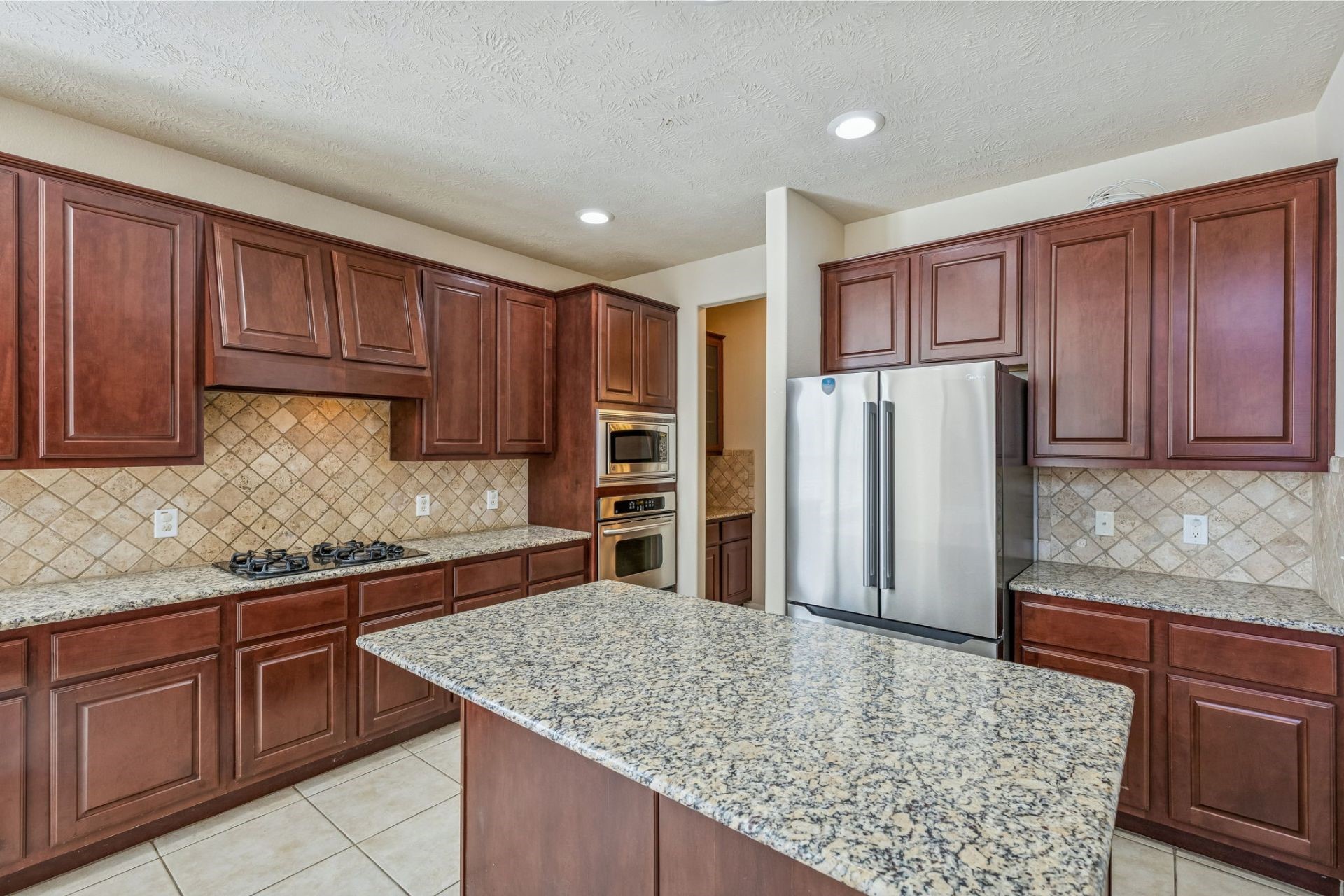6518 Montana Ridge Court Houston, TX 77041 - Photo 6 of 22 Well-appointed kitchen with granite countertops, stainless steel appliances, and effortless flow to the adjacent living and dining spaces.