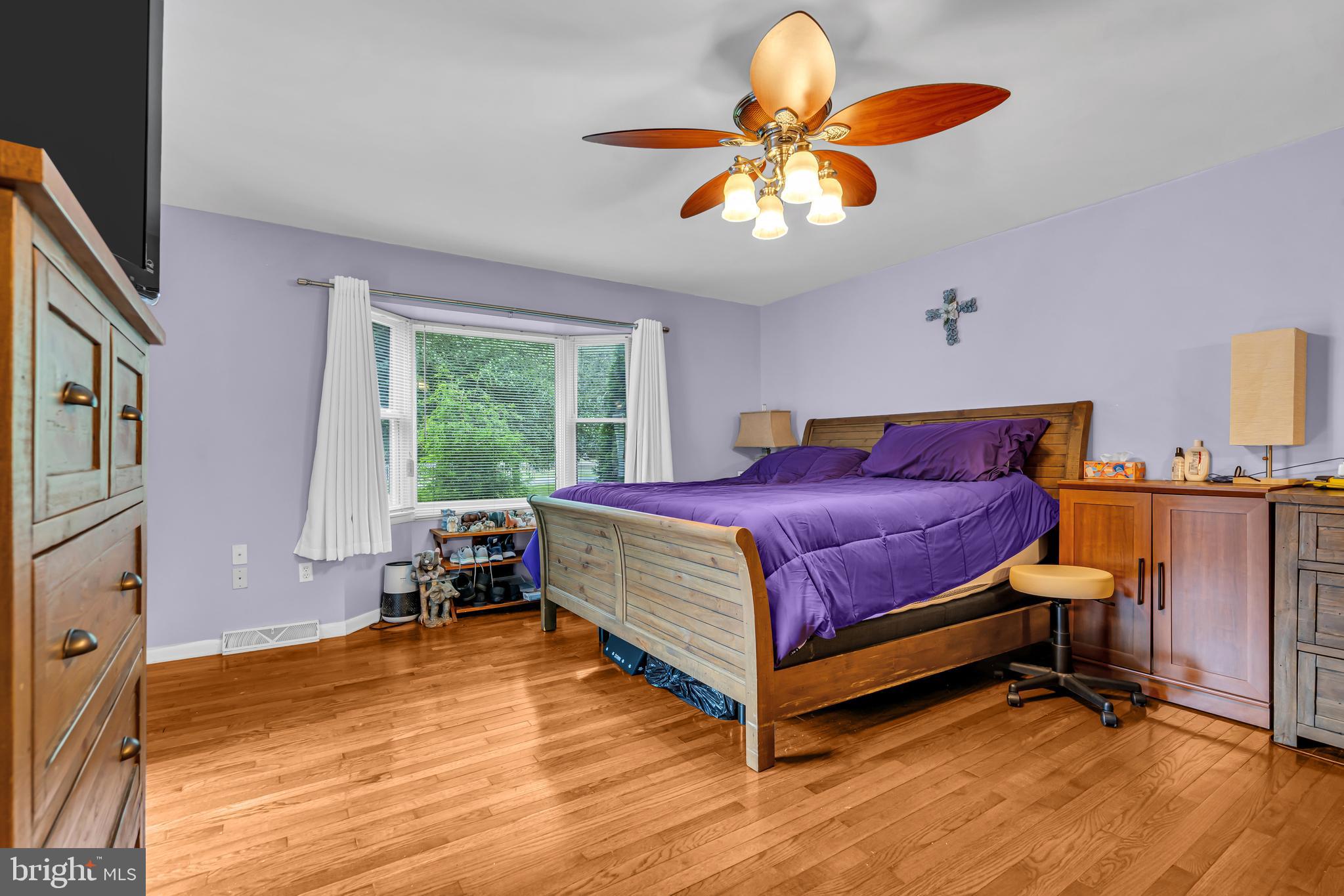 733 Buck Road Monroeville, NJ 08343 - Photo 16 of 24 a bed room with a bed and a chandelier