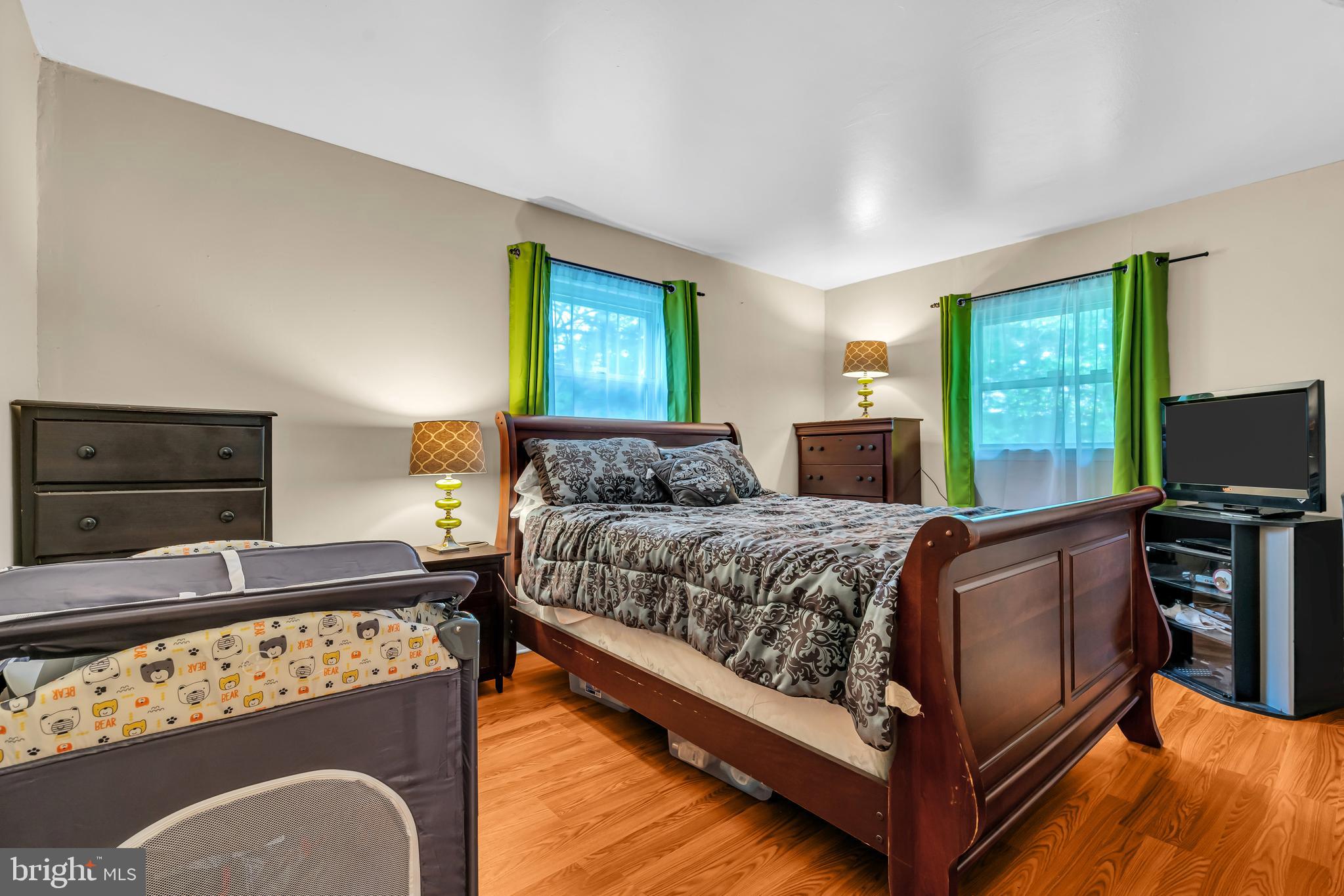 733 Buck Road Monroeville, NJ 08343 - Photo 18 of 24 a bedroom with a bed and a television