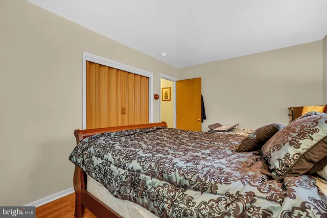 a bedroom with a bed and dresser