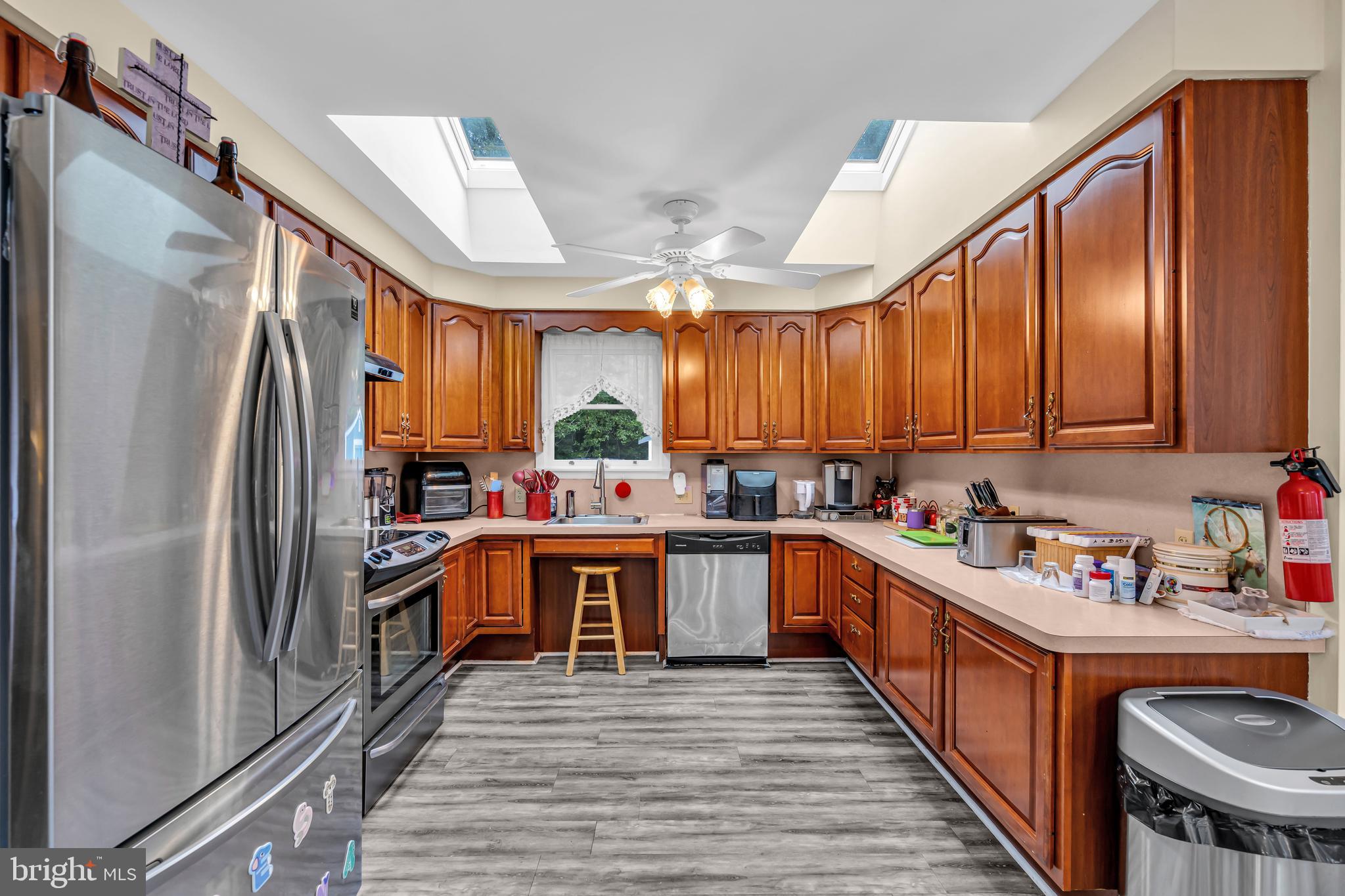 733 Buck Road Monroeville, NJ 08343 - Photo 7 of 24 a kitchen with stainless steel appliances a refrigerator a sink dishwasher a stove with wooden cabinets and floor