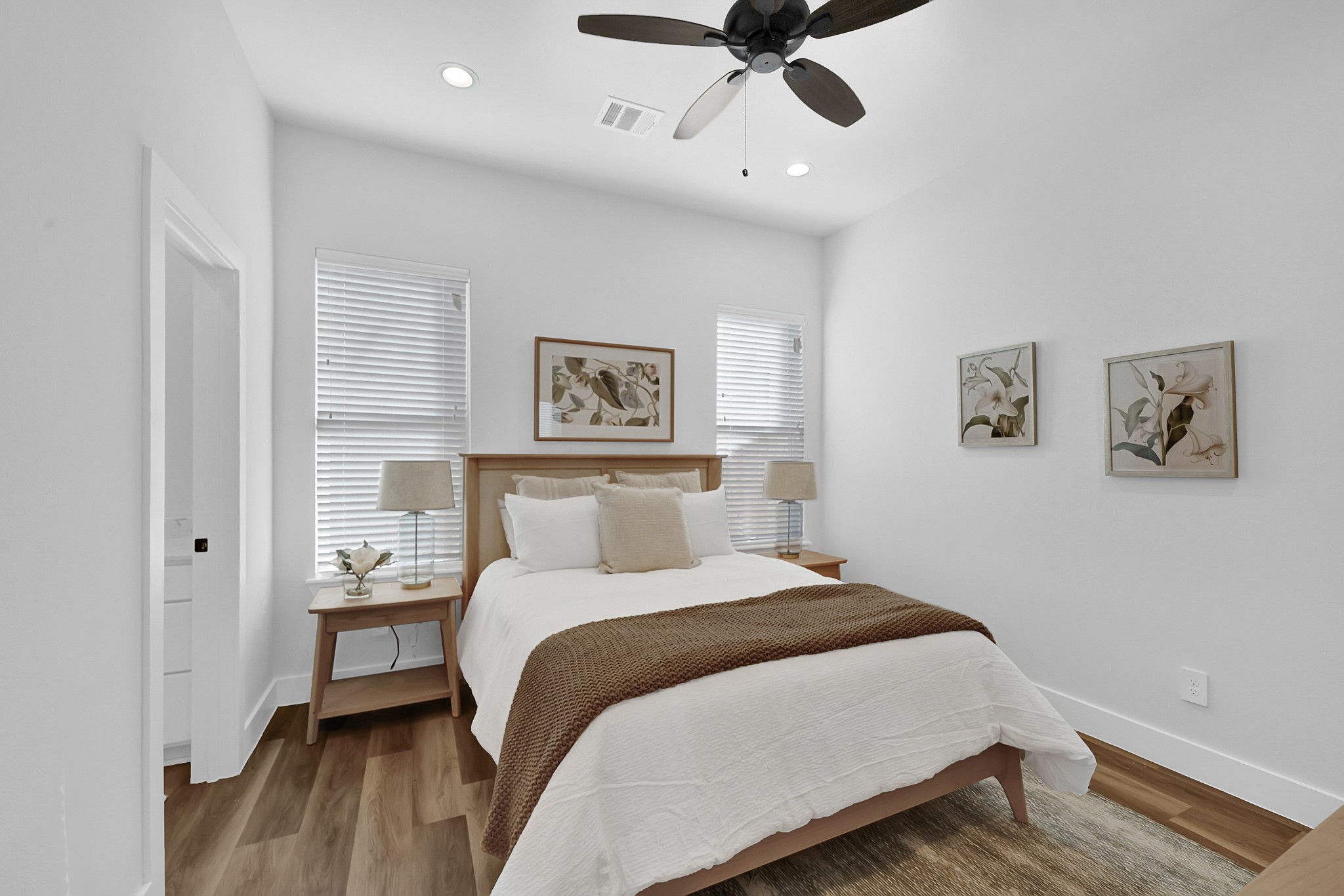 38634 Spur 149 Road, Unit 33B Magnolia, TX 77354 - Photo 10 of 48 a bedroom with a bed and wooden floor