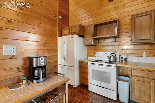 a kitchen with a stove and a refrigerator