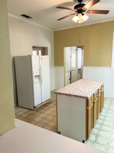 413 Fowzer Street Taylor, TX 76574 - Photo 4 of 9 Kitchen island, storage, utility room with cabinets in background