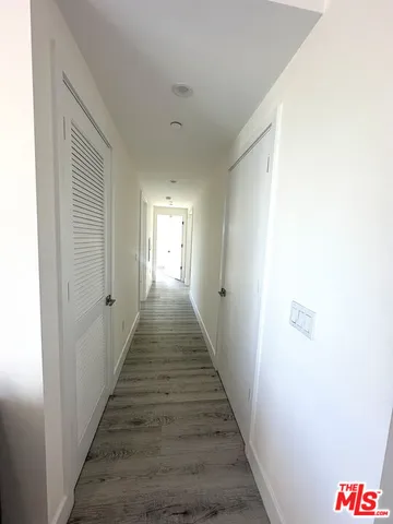 a hallway with wooden floor and entryway