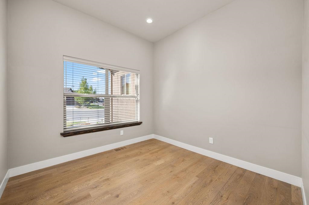 2592 Jay Court Grand Junction, CO 81505 - Photo 23 of 42 an empty room with wooden floor and windows