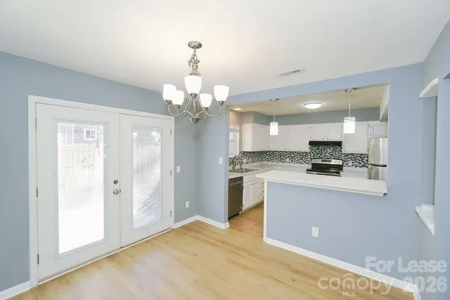 a view of a kitchen with a sink stainless steel appliances and cabinets