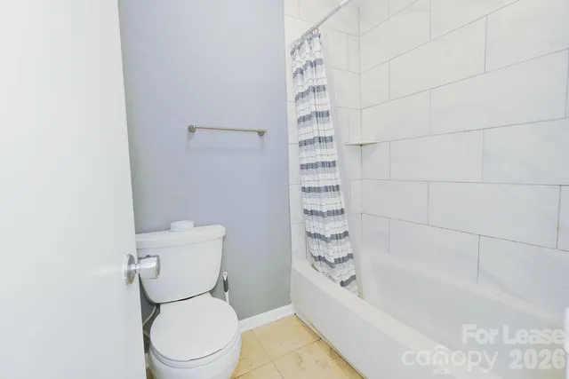 a bathroom with a toilet and a bathtub