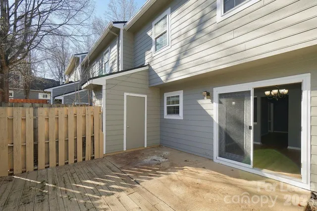 a view of a house with a wooden deck