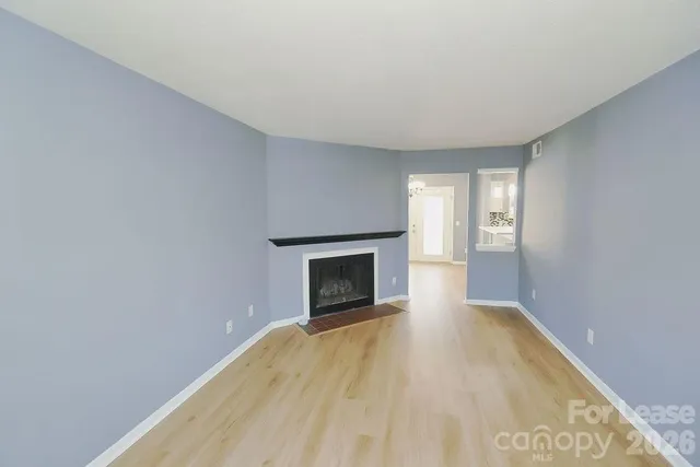 a view of empty room with a fireplace