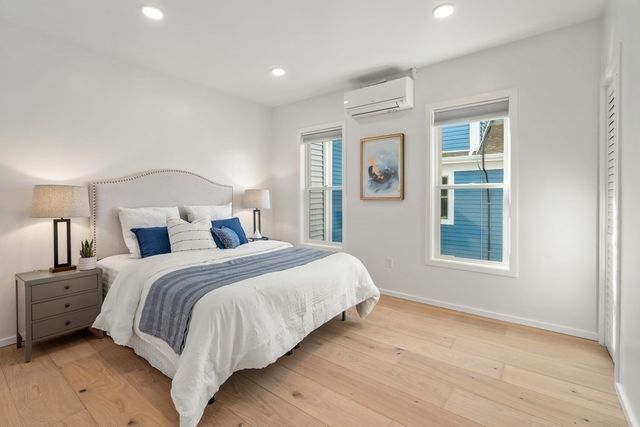 a bedroom with a large bed and a window