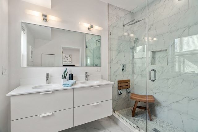 a bathroom with a double vanity sink mirror and double