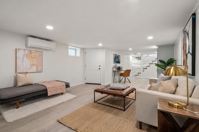 a living room with furniture and a rug