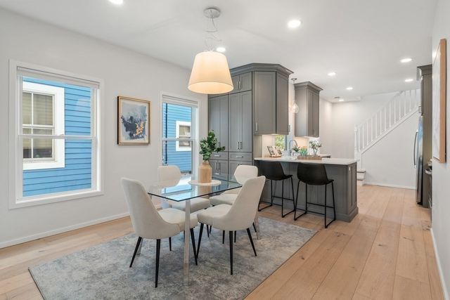 a view of a a dining room with furniture window and wooden floor