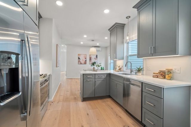 a kitchen with a sink refrigerator and cabinets