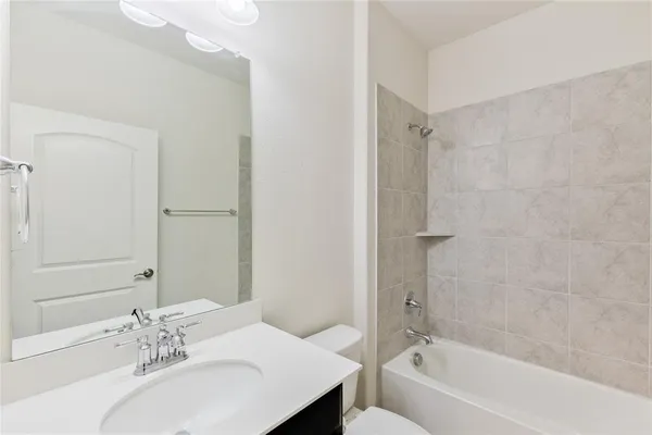 a bathroom with a bathtub shower sink and a mirror