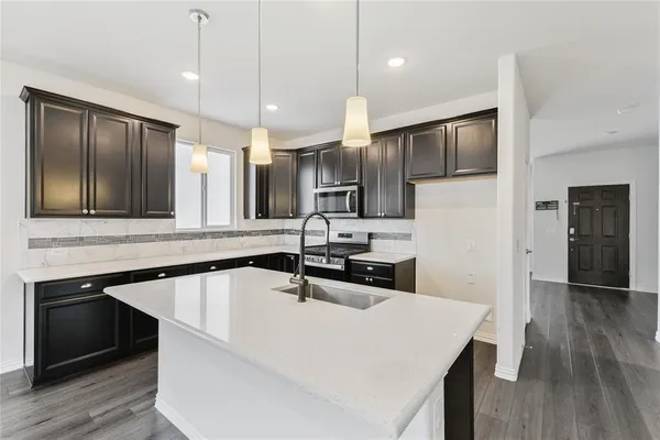 a large kitchen with a table and chairs in it
