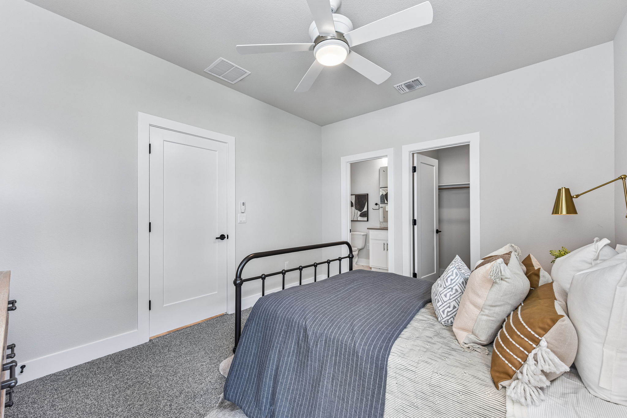 9101 Cattle Baron Path Austin, TX 78747 - Photo 28 of 40 A tranquil bedroom features plush carpeting and a modern ceiling fan, offering a serene escape.
