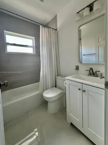 a bathroom with a sink a toilet and a bathtub