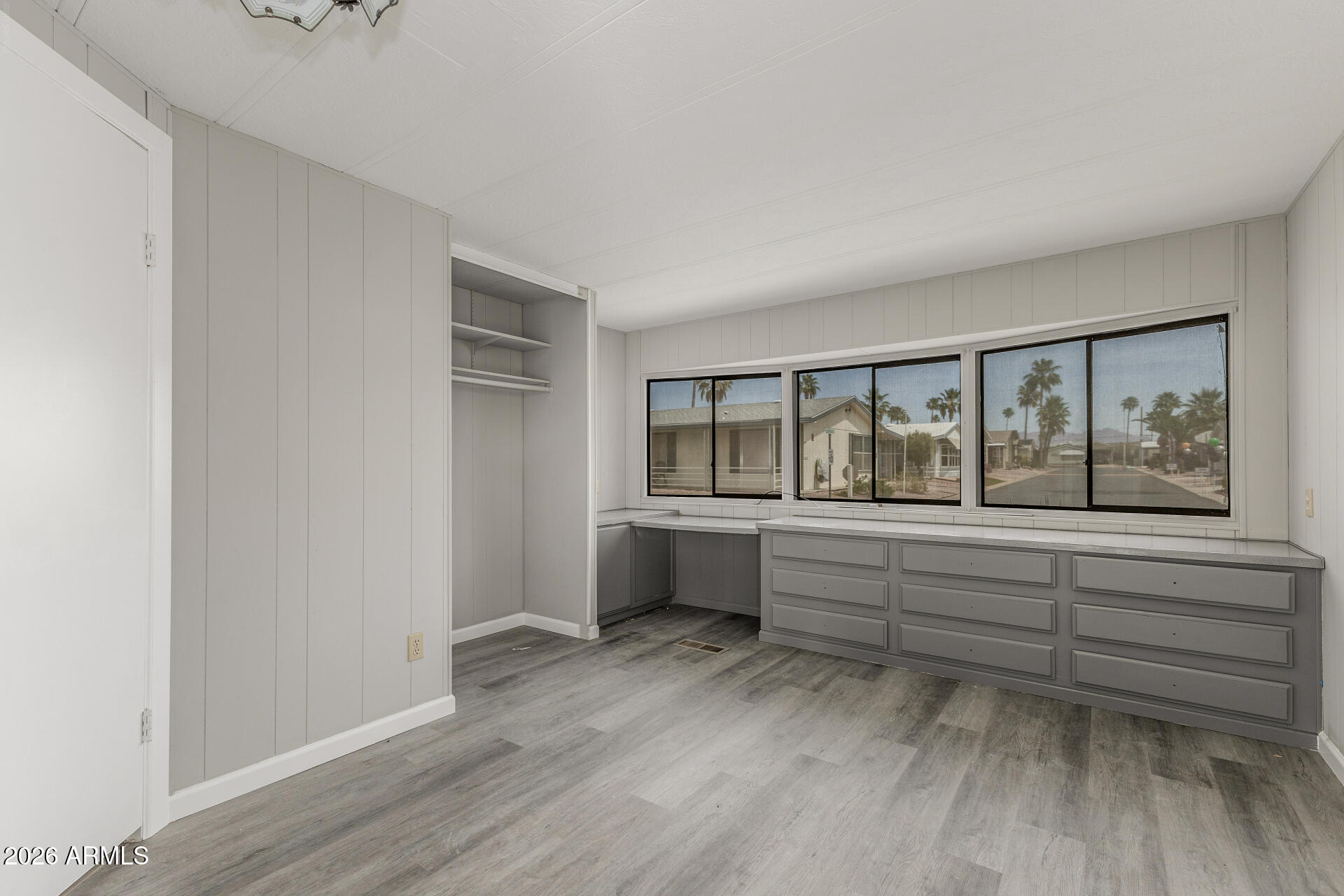 9302 East Broadway Road, Unit 155 Mesa, AZ 85208 - Photo 16 of 26 a large white room with wooden floor and balcony