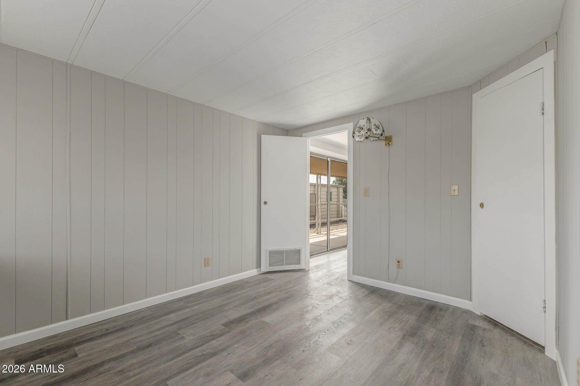 9302 East Broadway Road, Unit 155 Mesa, AZ 85208 - Photo 17 of 26 a view of an empty room and wooden floor