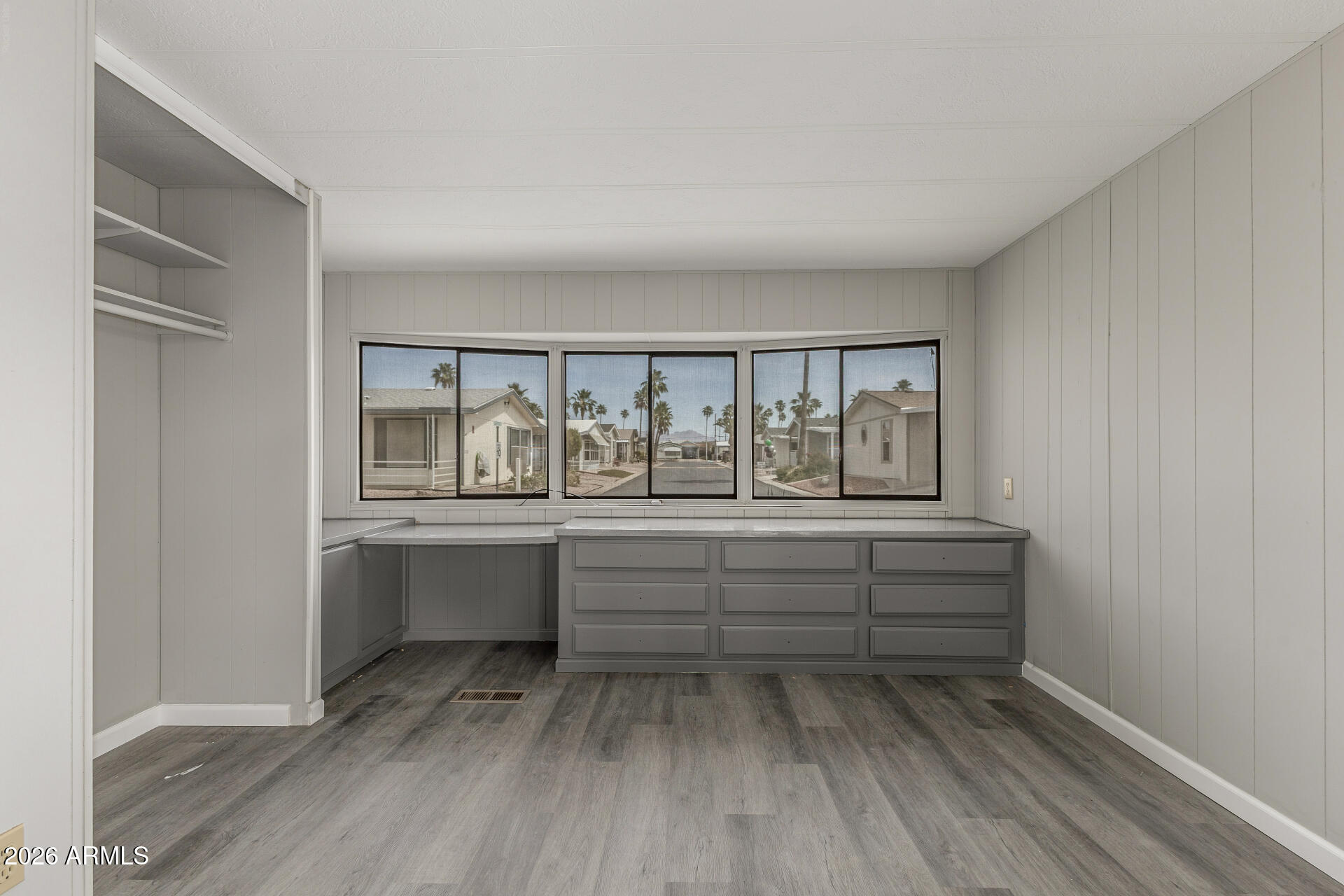 9302 East Broadway Road, Unit 155 Mesa, AZ 85208 - Photo 18 of 26 a room with wooden floor and balcony