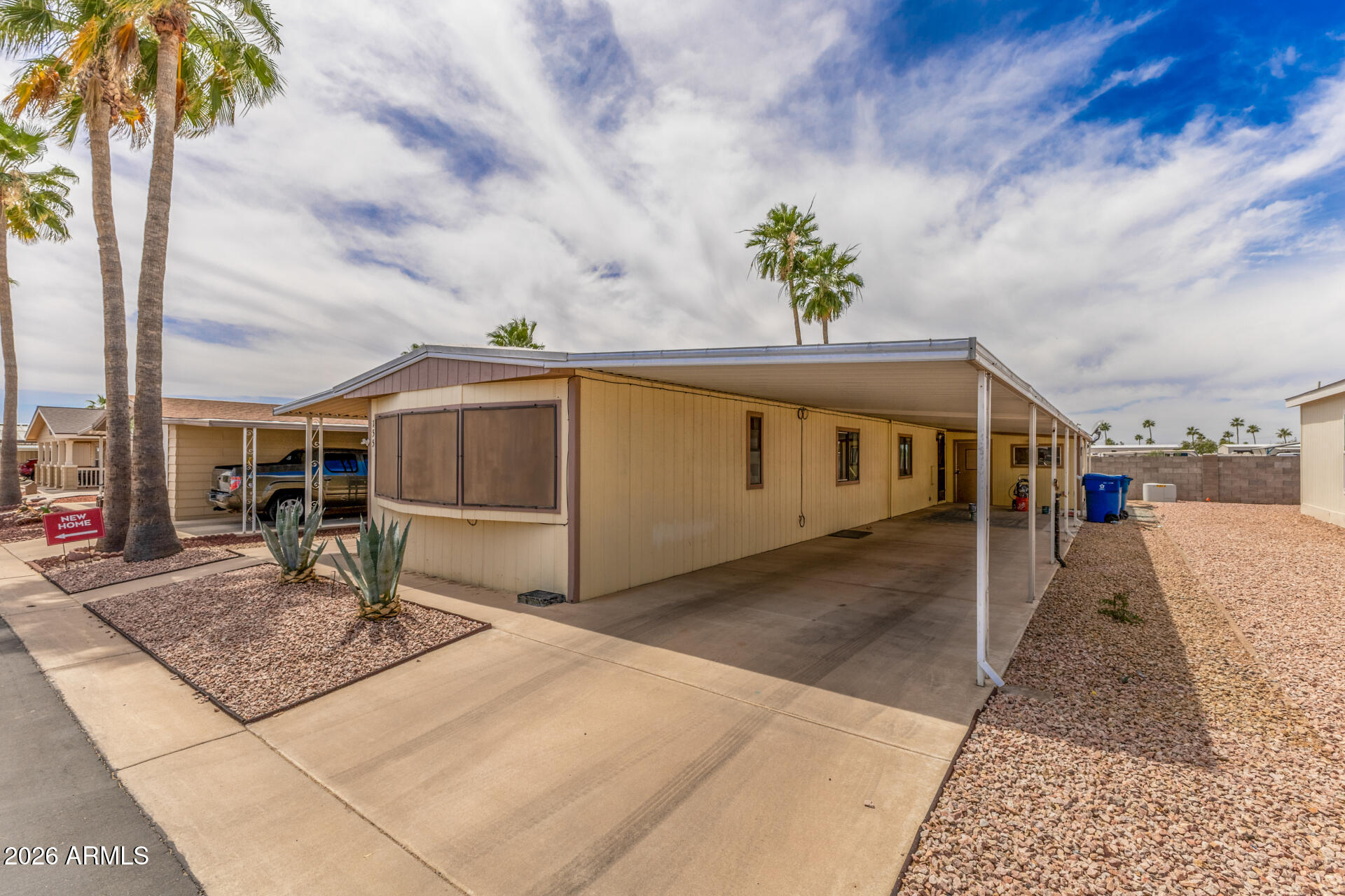 9302 East Broadway Road, Unit 155 Mesa, AZ 85208 - Photo 2 of 26 a front view of a house with a yard and garage