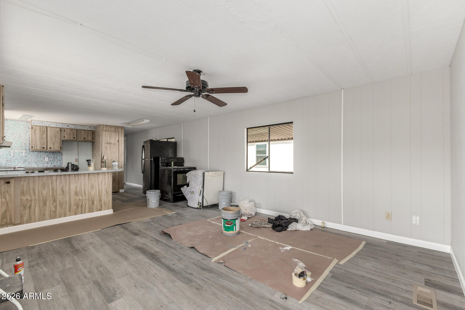 9302 East Broadway Road, Unit 155 Mesa, AZ 85208 - Photo 4 of 26 a view of a kitchen with a sink hardwood floor and a ceiling fan