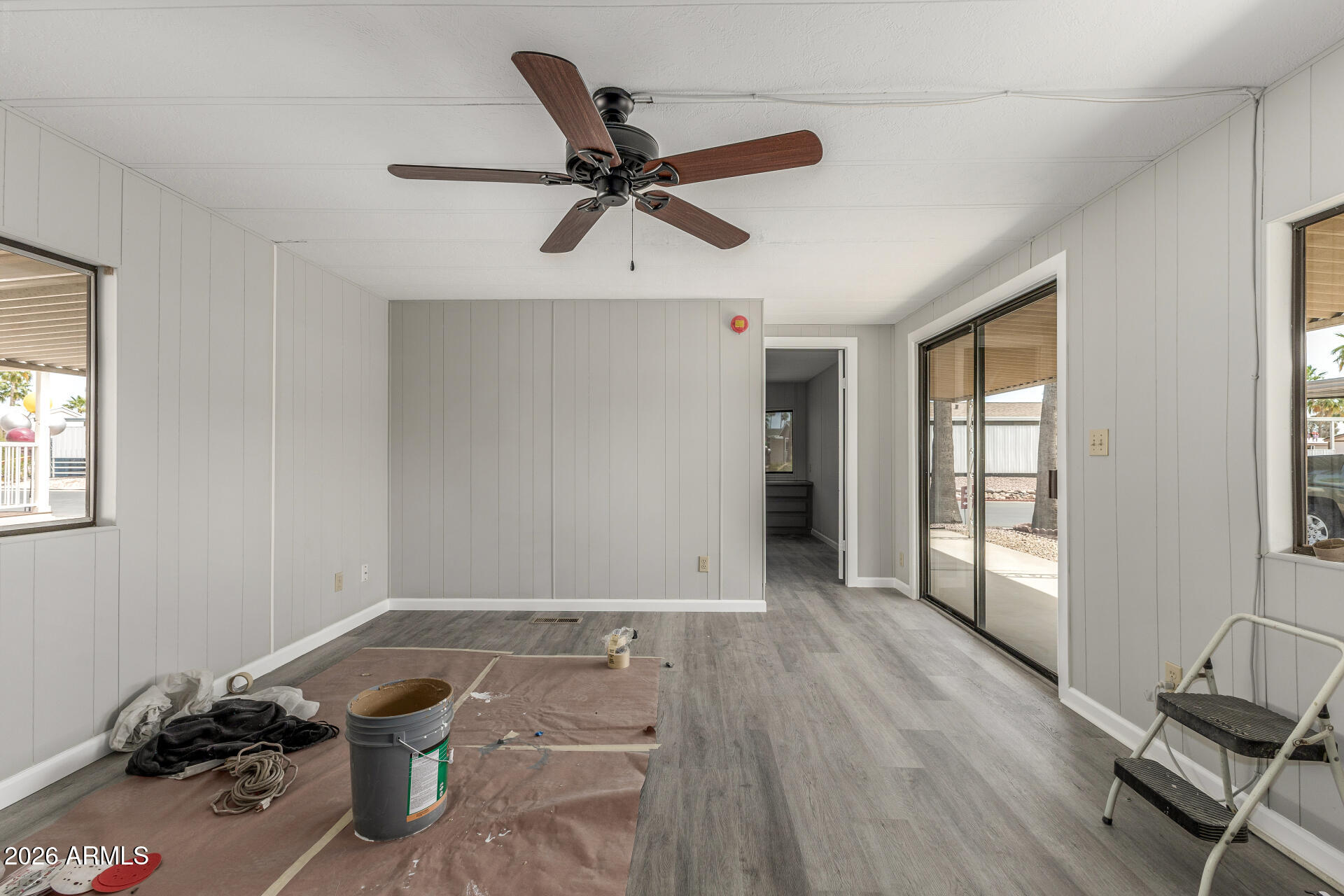 9302 East Broadway Road, Unit 155 Mesa, AZ 85208 - Photo 7 of 26 a view of a livingroom with a ceiling fan and window