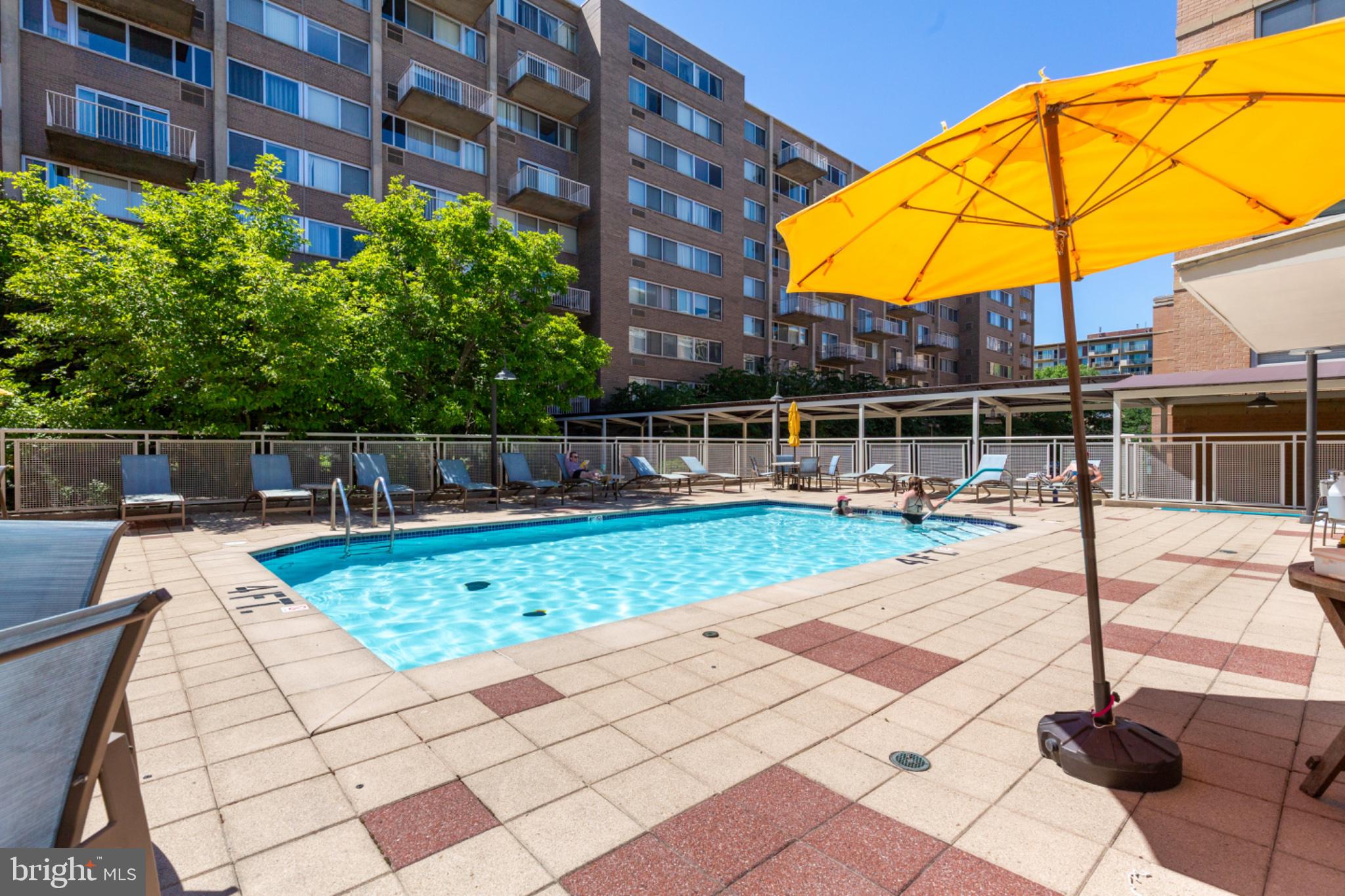 350 G Street Southwest, Unit N423 Washington, DC 20024 - Photo 27 of 43 Sunny poolside retreat with vibrant umbrella.