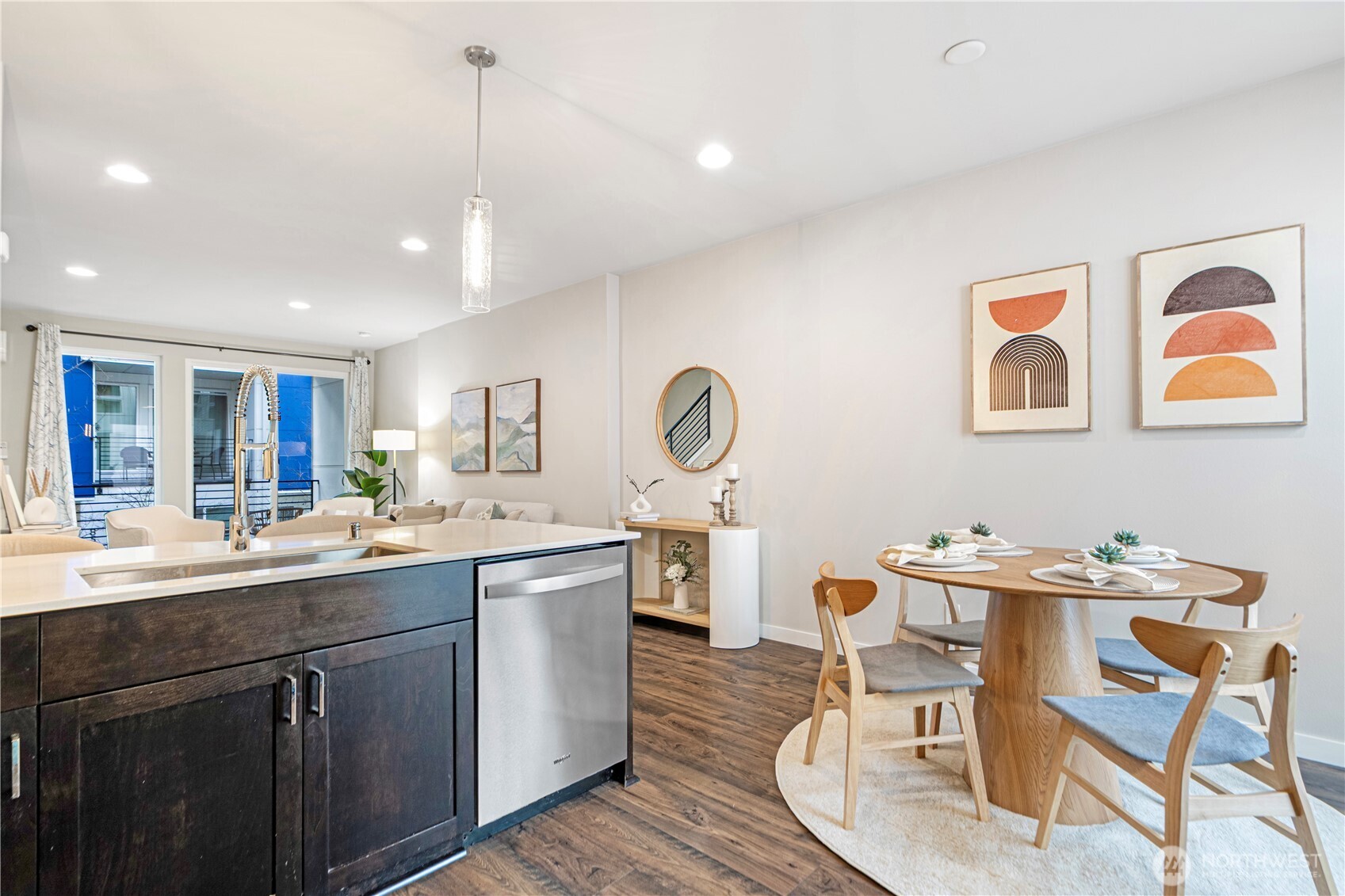 8554 22nd Place Northeast Seattle, WA 98115 - Photo 15 of 35 a dining hall with stainless steel appliances granite countertop a sink and dishwasher with wooden floor