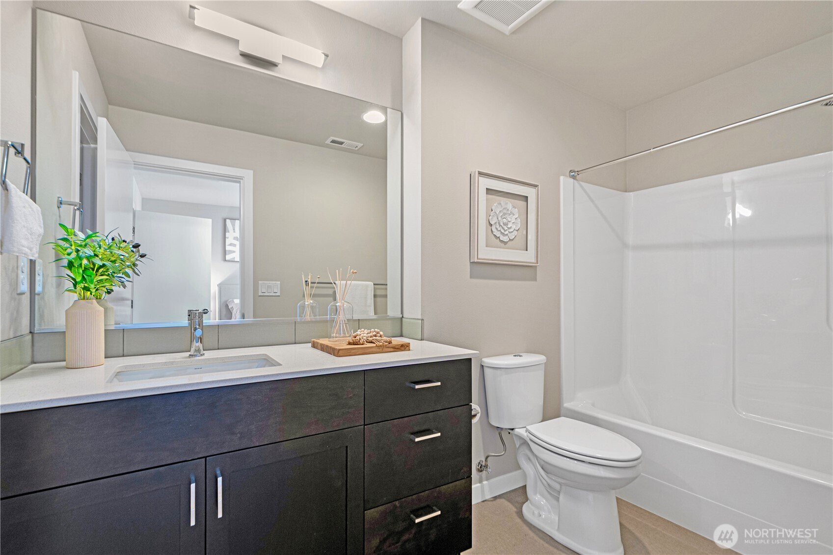 8554 22nd Place Northeast Seattle, WA 98115 - Photo 23 of 35 a bathroom with a toilet a sink a large mirror and shower