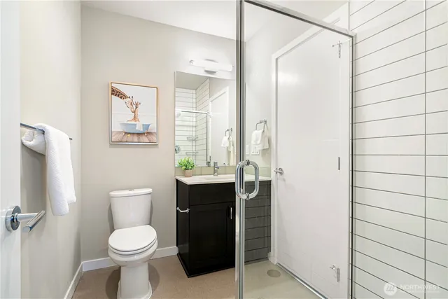 a bathroom with a toilet a sink and shower