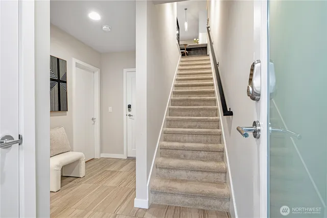 a view of a hallway with wooden floor and entryway