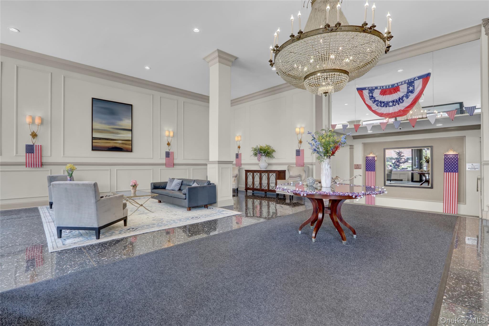 700 Shore Road, Unit 4K Long Beach, NY 11561 - Photo 19 of 31 a living room with furniture and a chandelier