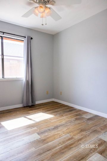 1012 Conejo Avenue Ridgecrest, CA 93555 - Photo 17 of 24 an empty room with wooden floor and windows