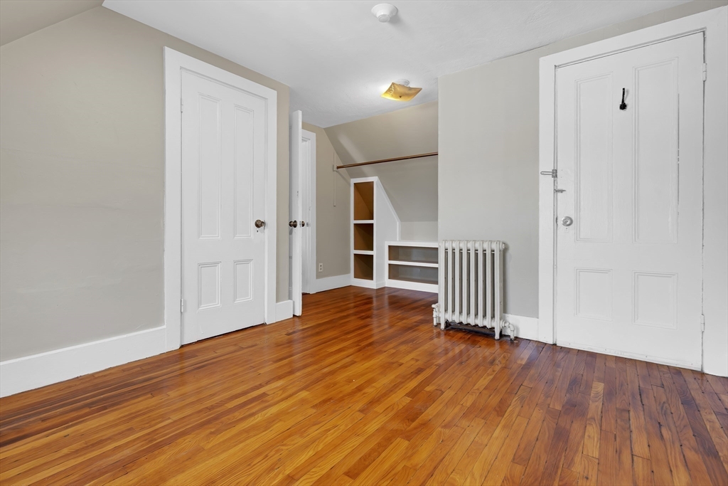 28 Evergreen Street, Unit 3 Boston, MA 02130 - Photo 12 of 16 a view of empty room with wooden floor