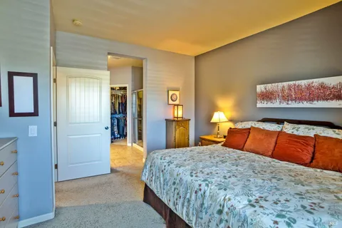 a bedroom with a bed and lamp