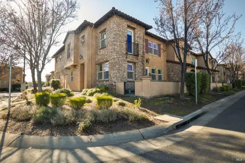 a view of a white house with a yard covered in snow